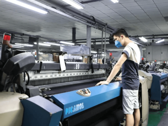Laboratory testing lightweight denim fabric for strength, colorfastness, and performance