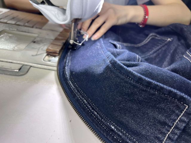 Close-up of reinforced stitching and seam finishing on a custom maxi dress