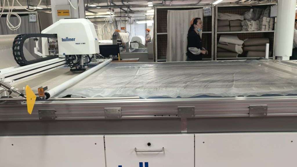 Bullmer automatic cutting system for precision fabric layering and bulk production at Newasia Garment