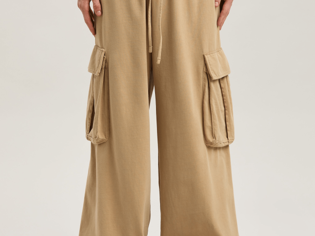 Industrial workers wearing durable cargo pants with multiple utility pockets for construction and warehouse operations