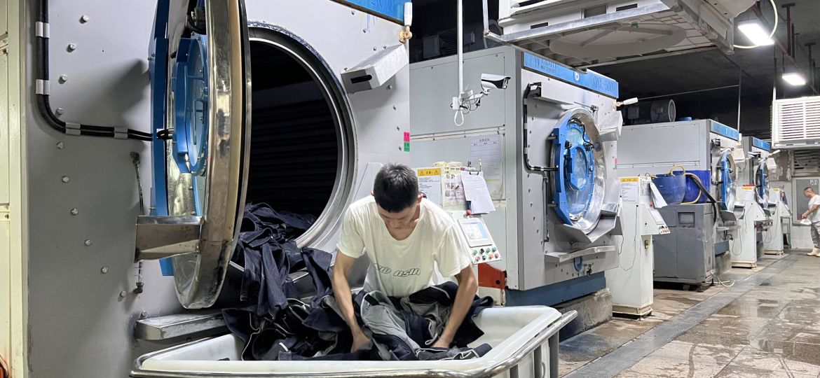 Professional denim washing process creating fashionable finishes and consistent garment quality