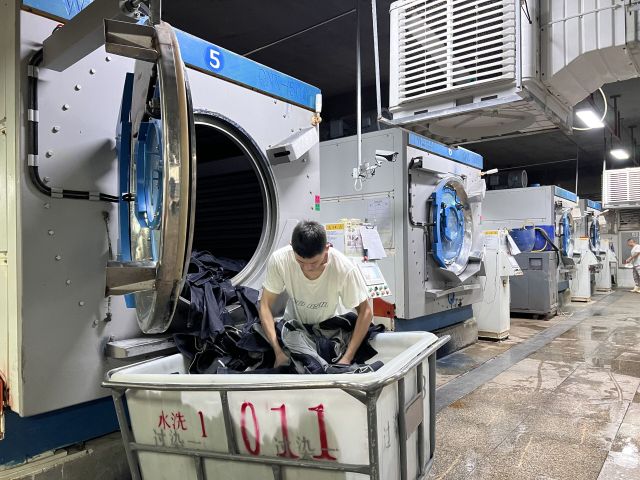 Professional denim washing process creating fashionable finishes and consistent garment quality