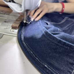 Metal zipper button and hardware details used in high-quality denim skirt manufacturing