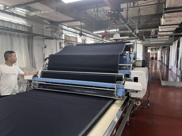 Denim fabric inspection checking color shade texture weight and material consistency before production