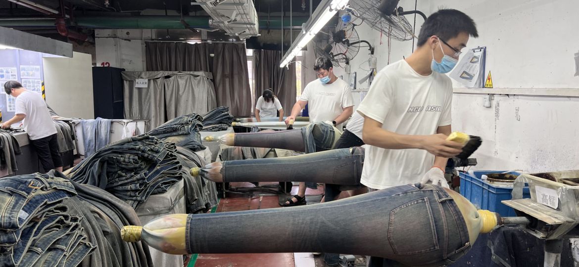 Authentic denim whiskering effect developed through professional washing and finishing techniques