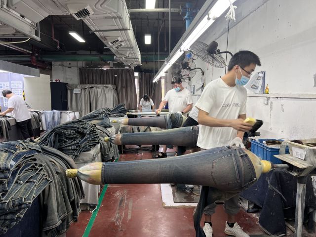 Authentic denim whiskering effect developed through professional washing and finishing techniques