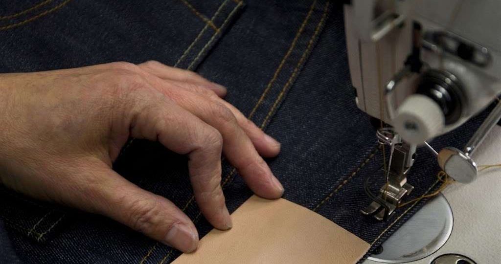 Skilled workers sewing denim skirts with reinforced stitching and quality craftsmanship