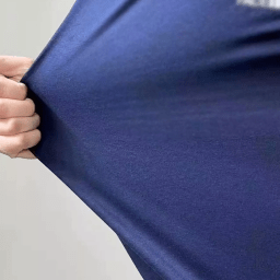 Close-up of heavyweight cotton jersey fabric showing dense knit texture and premium hand feel