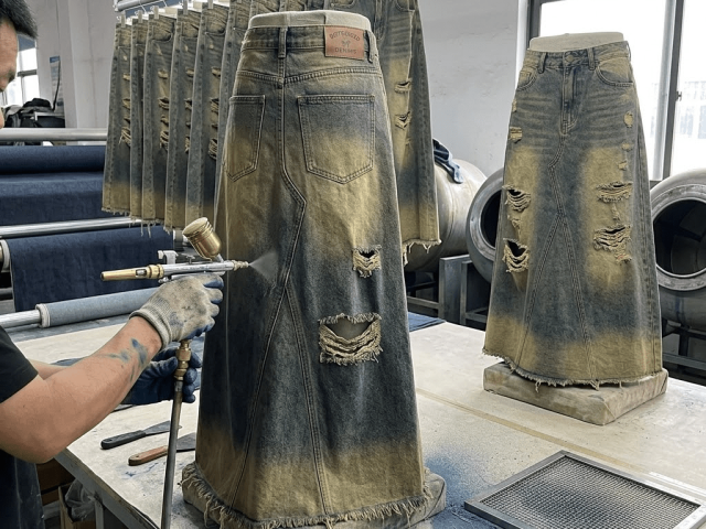 Laser and hand distressing techniques for fashionable denim skirt production