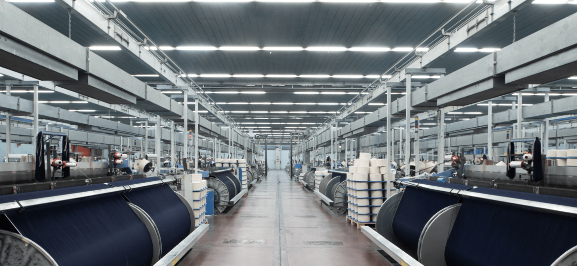 Clean and organized denim manufacturing workshop demonstrating professional production management