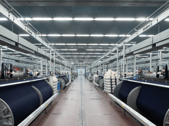 Clean and organized denim manufacturing workshop demonstrating professional production management