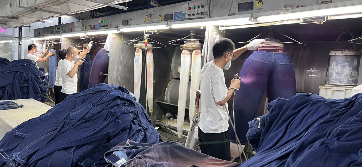 Woman adjusting off-the-rack jeans fit for better waist and length comfort