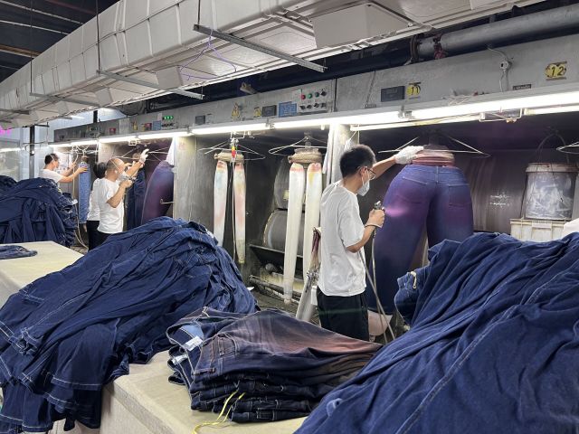 Woman adjusting off-the-rack jeans fit for better waist and length comfort