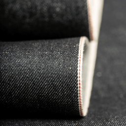 Close-up of raw selvedge denim fabric edge showing authentic selvedge weave line