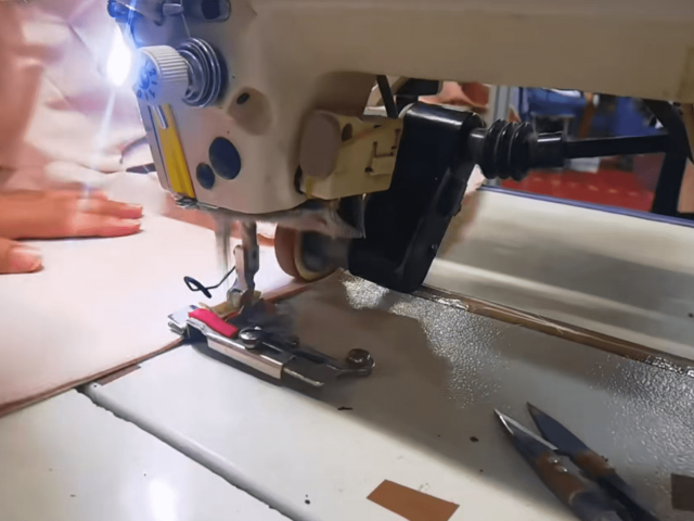 Skilled workers sewing garments with professional stitching techniques and production control