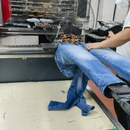 Distressing and vintage finishing process for custom denim jeans