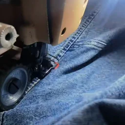 Reinforced stitching detail showing durable construction of denim garments