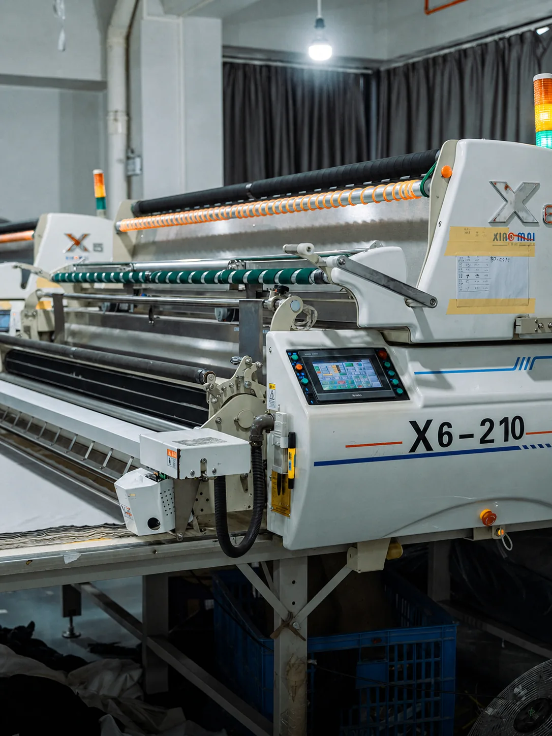 Automated fabric spreading before OEM apparel cutting