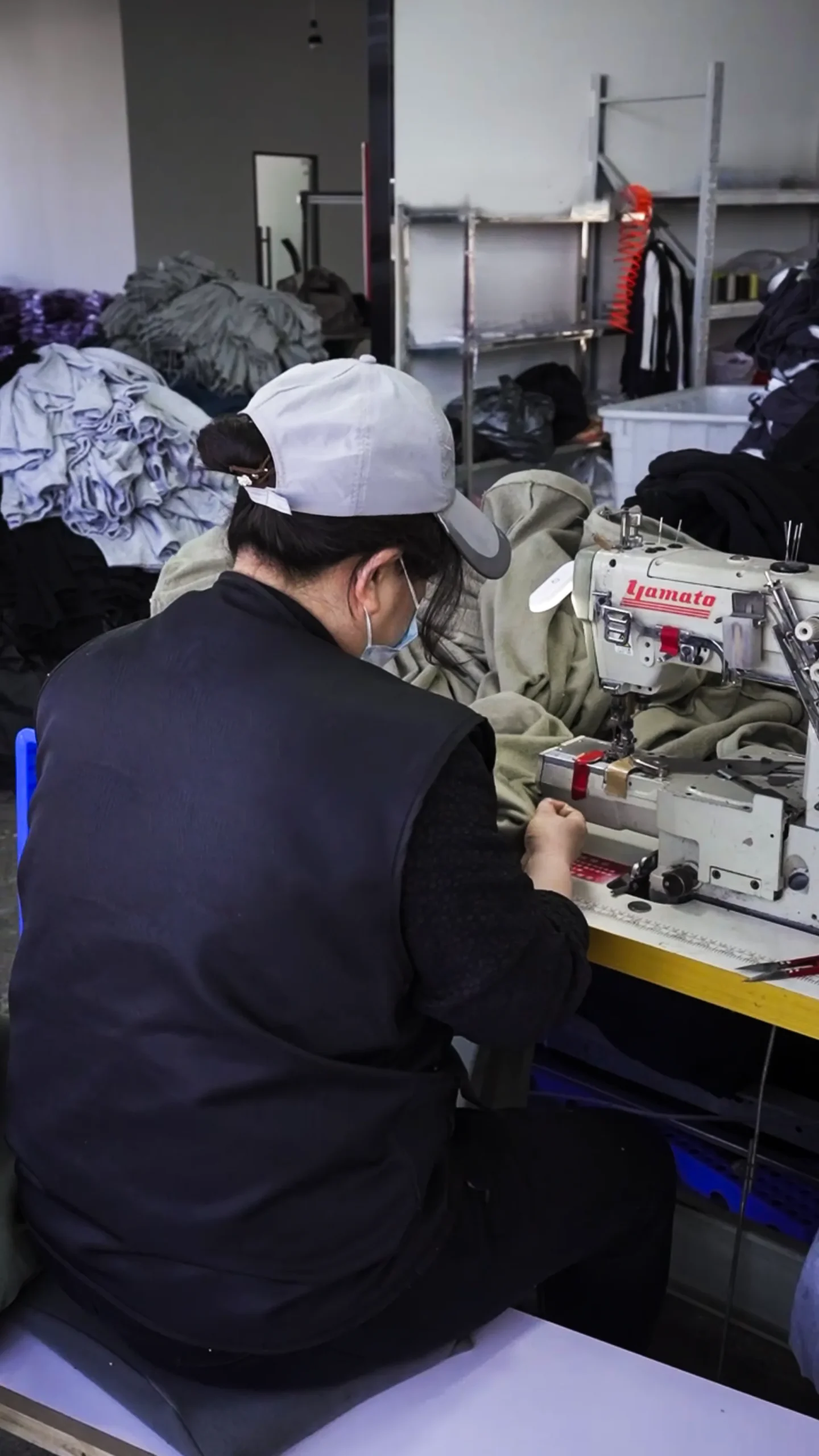 Close-up workmanship checkpoint during OEM garment sewing