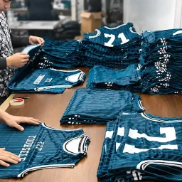 Quality control inspection of custom sports jerseys in garment manufacturing