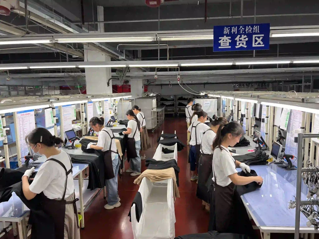 Apparel manufacturing production line with in-process garment quality inspection